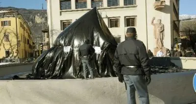 Trento, proteste contro il governo: giovani coprono fontana con un telo nero