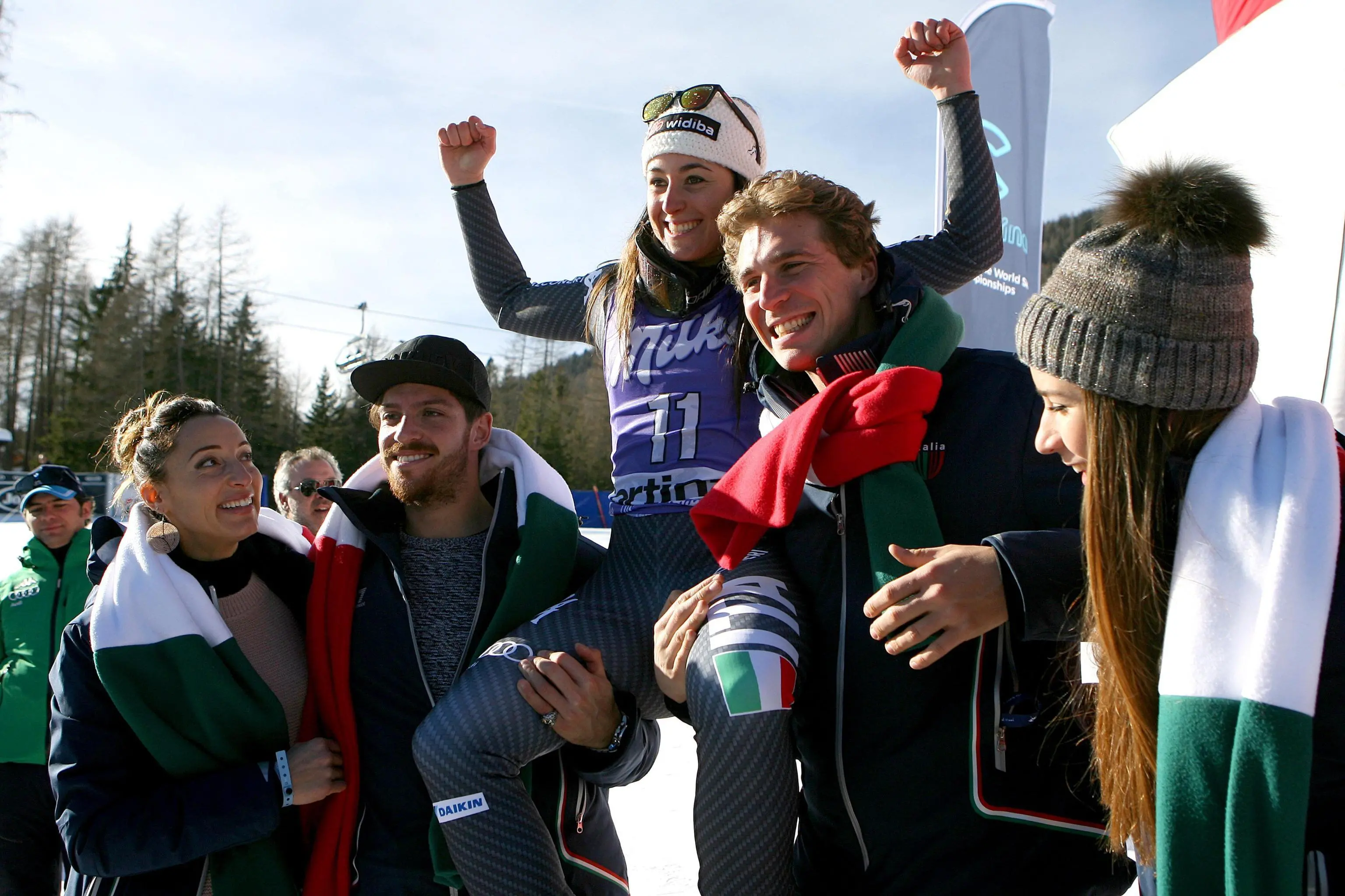 Sofia Goggia (C) of Italy celebrates her second placed in the finish area with Italian athletes Elisa Di Francisca and Marco Di Costanzo (L) after the Downhill race of the Alpine Skiing World Cup Women in Cortina d'Ampezzo, Italy, 28 January 2017. Gut won ahead of second placed Sofia Goggia of Italy and third placed Ilka Stuhec of Slovenia. ANSA/ANDREA SOLERO