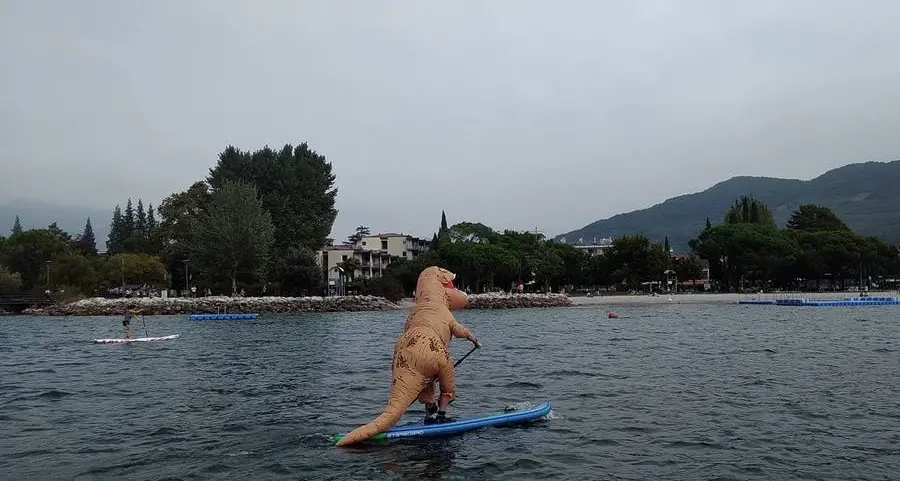 Sul lago il dinosauro con il paddle