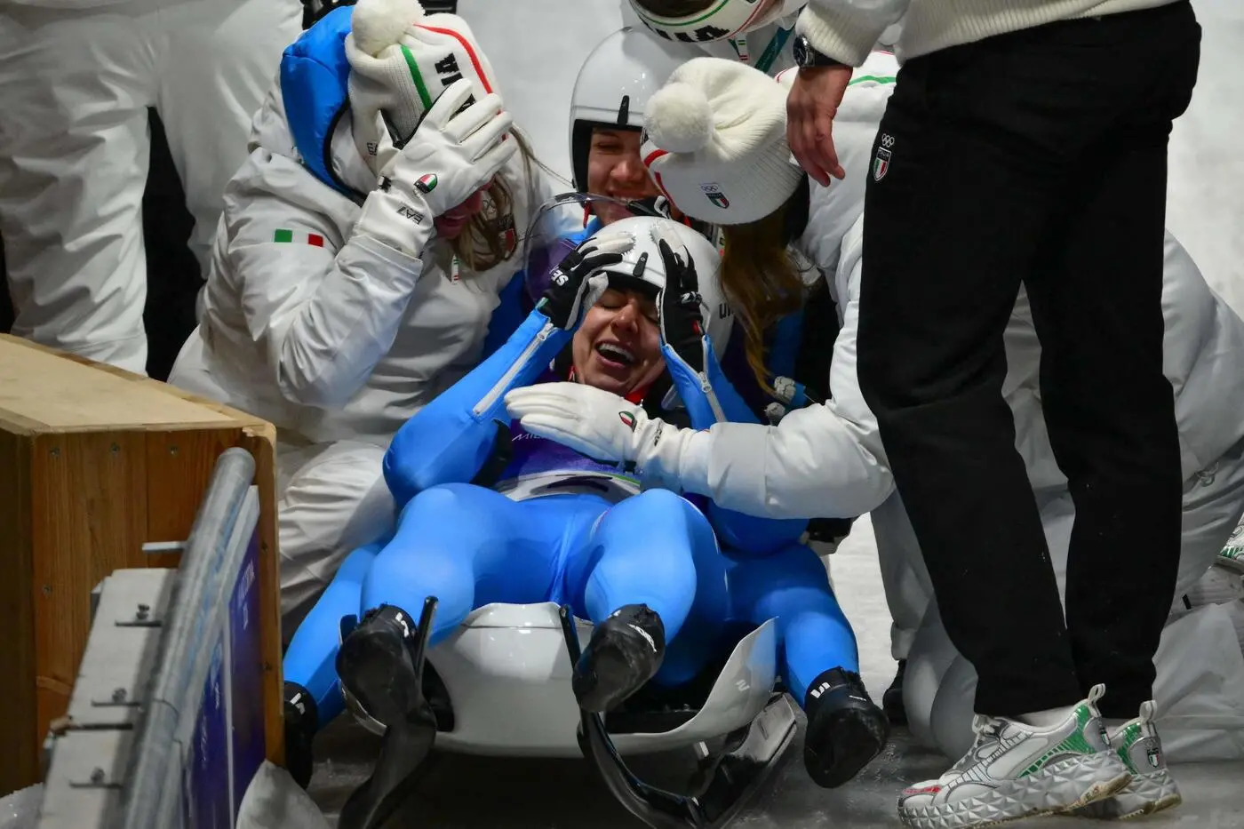 Italy's Andrea Voetter and Marion Oberhofer celebrate winning the gold medal in the luge women's doubles at Cortina Sliding Centre during the Milano Cortina 2026 Winter Olympic Games in Cortina d'Ampezzo on February 11, 2026. (Photo by Stefano RELLANDINI / AFP)