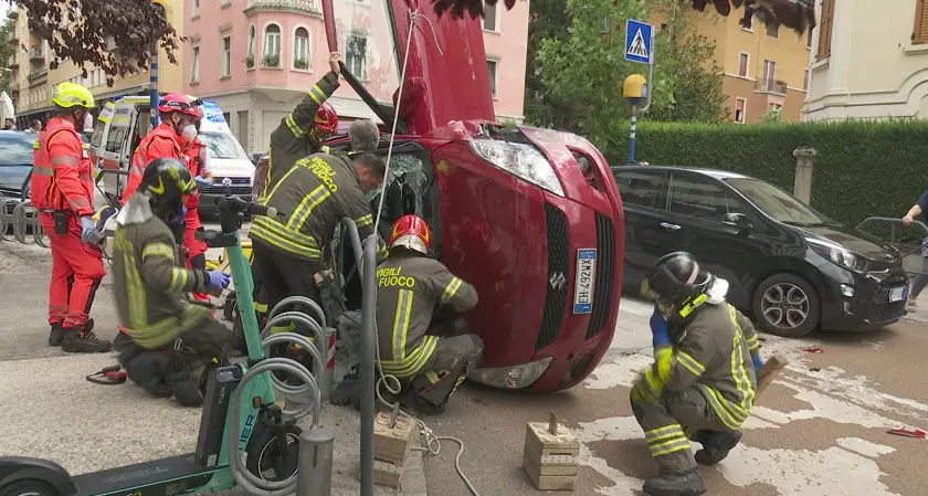 Trento, tenta di sterzare all'ultimo per evitare incidente ma si ribalta: paura in Via Perini
